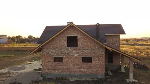 Aerial View of Unfinished House with Wooden Roof Structure Covered with Metal Tile Sheets Under