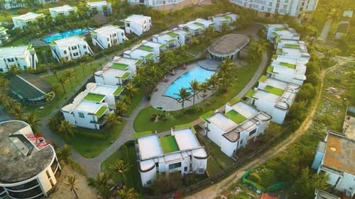 Aerial View Showcasing Tropical Resort's Central Pool Verdant Bungalows Nestled Around Basking in