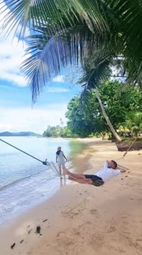 a Man is Laying in a Hammock on a Beach Koh Mak Thailand