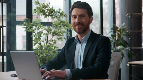 Caucasian Businessman Typing Laptop Office Smiling Looking at Camera Portrait Professional Male