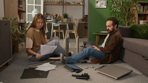 Couple Assembling Furniture Together in Living Room