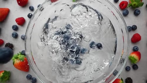 Blueberries Falling into Water with Mixed Berries