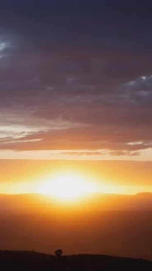 Vibrant Sunset Over Dark Mountain Range