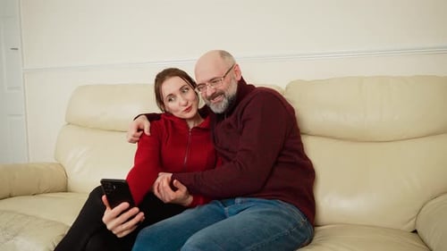 Loving Couple Taking Fun Selfie Photo on Couch