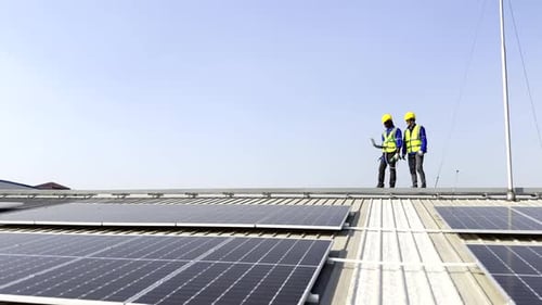 Technician installing solar cell. Installation and maintenance of solar cells on rooftop.