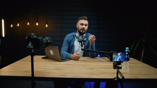 Man Recording Video Podcast on Camera and Phone