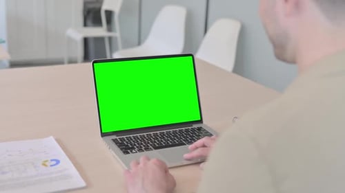 Businessman Using Laptop with Green Screen