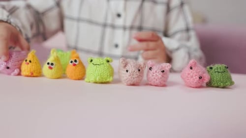 Child Plays with Colorful Handmade Crocheted Toys