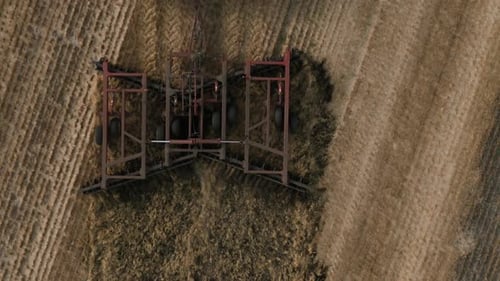 Disking the Field Big Red Tractor Cultivating Land of Disc Harrow Tractor at a Disking of Ground