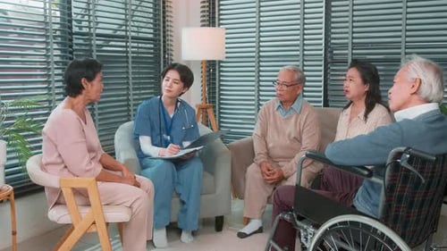 Medical Professional Talking with Seniors in Living Room