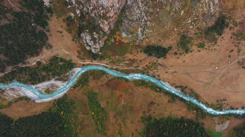 Aerial view of river surrounded with green trees and mountains