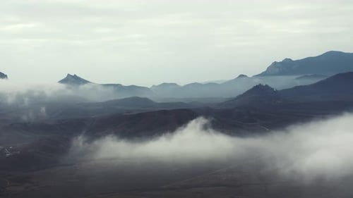 Mountain Landscape in the Fog Under a Cloudy Sky