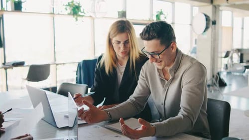 A Group of Colleagues Collaborate on a Modern Office Project Focusing on Teamwork and Creativity for