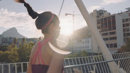 Athlete running outside in the city on sunny day