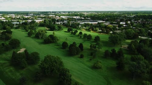 Aerial drone shot over a beautiful Golf club in Northbrook Illinois, USA in a town on a cloudy day.