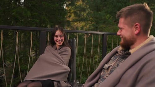 Woman Smiles to Boyfriend on Hotel Terrace