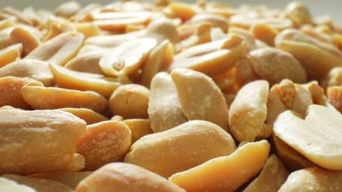 A macro shot of roasted peanuts.