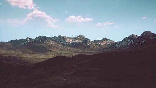 A Scenic Mountain Range with Billowing Clouds in the Sky