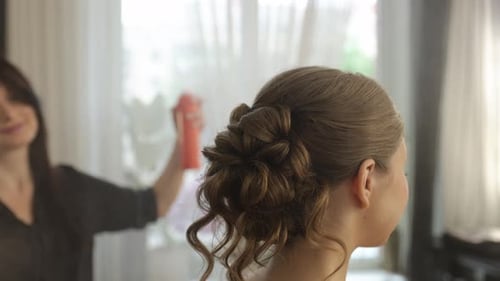 Hairdresser Spraying Hairspray on a Beautiful Bride's Hairstyle