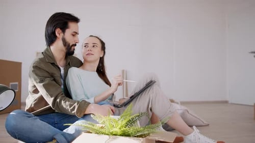 Side View of Young Couple with Tablet Moving and Planning in New