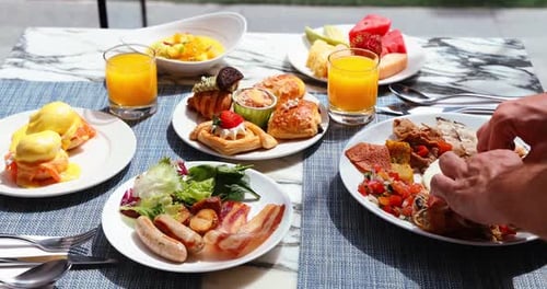 Extensive Buffet Style Breakfast Display with Pastries and Meats