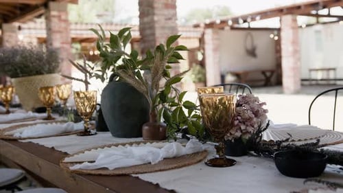 Wedding event table with glasses plates and flower pot decorations summer garden party