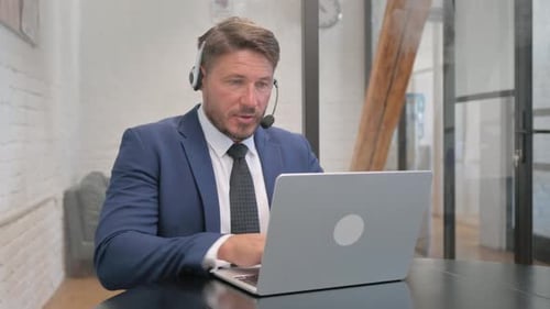 Call Center Employee Doing Video Chat via Laptop