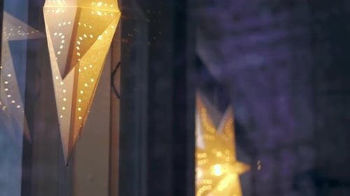 Christmas stars lamps hanged on window. Close up