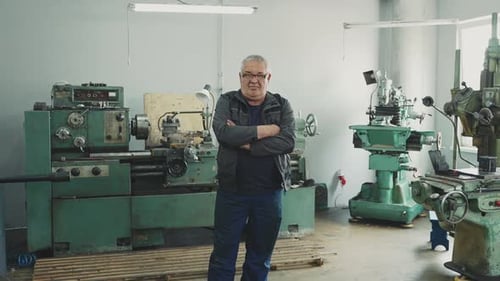 Man Standing in Front of Large Industrial Machines