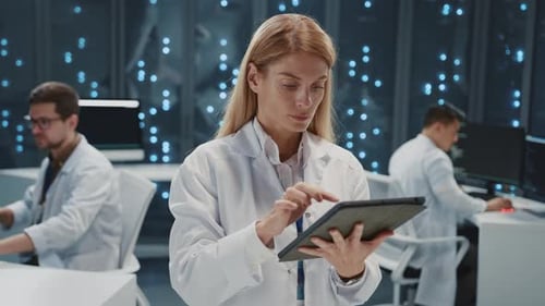 Woman Using Tablet in a Futuristic Lab
