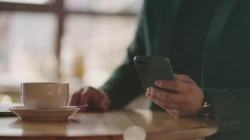 Closeup of a Man's Hand with a Mobile Phone Online Shopping Trading Messaging or Trading