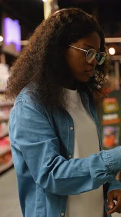 African American Woman Choosing Window Cleaning Detergent
