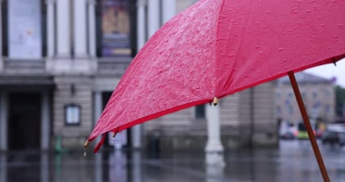 Red Umbrella on Rainy Day in Urban Setting