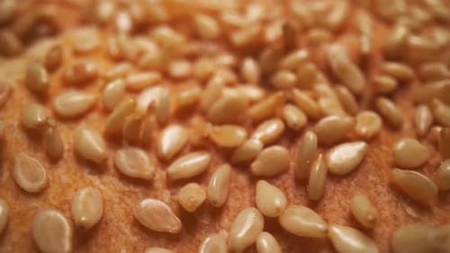 Sesame Seeds Being Added to Bread in Close Up