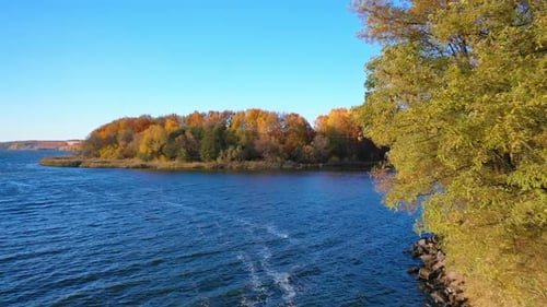 Autumn forest and river from air. Autumn in the wild on the background of the forest and the river