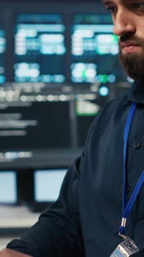 Vertical Video Technician Coding in High Tech Facility with Server Rows Close Up Shot