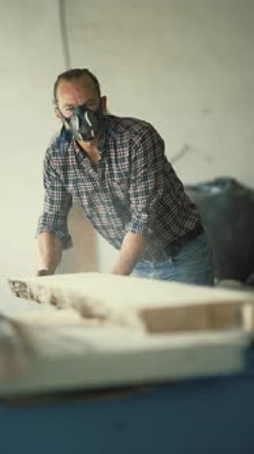 Carpenter Wearing Respirator Mask Processing Wood Plank