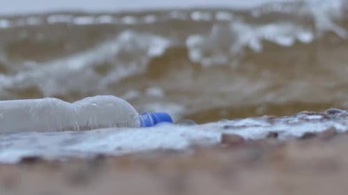 Plastic bottle by the sea. Plastic as waste. Environmental pollution problem concept