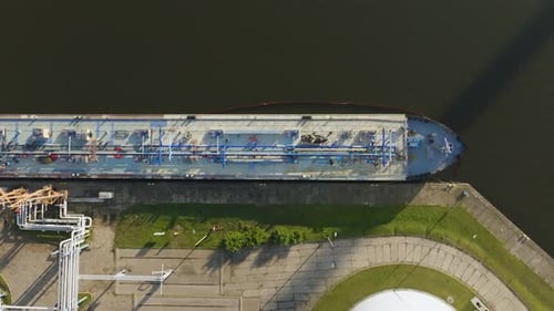 Aerial view of large tanker ship loading fuel at oil terminal operations