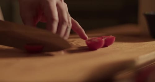 Tomato Being Sliced on Cutting Board