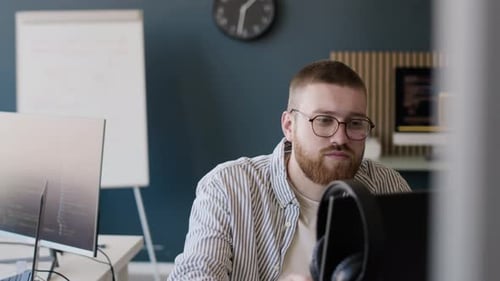 Young Sysadmin Putting On Headphones