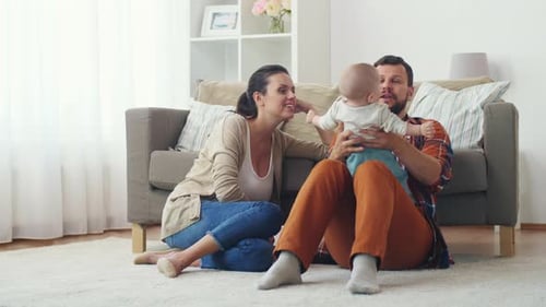 Happy Family Relaxing at Home with Baby