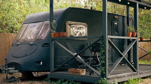 A mobile home with a terrace is located in country glamping site for relaxation and solitude nature