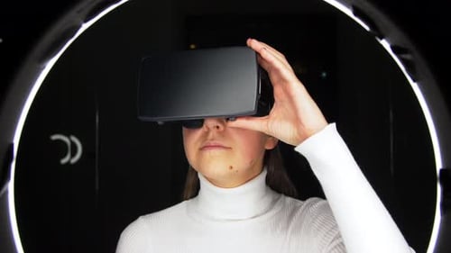 Young Woman Experiencing Virtual Reality Headset Indoors