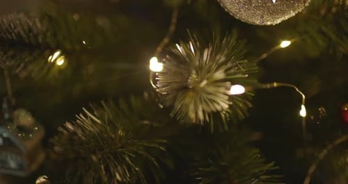 Happy New Year Christmas Tree Decorates on Branch Snow on Background Bokeh of Side Flickering Light