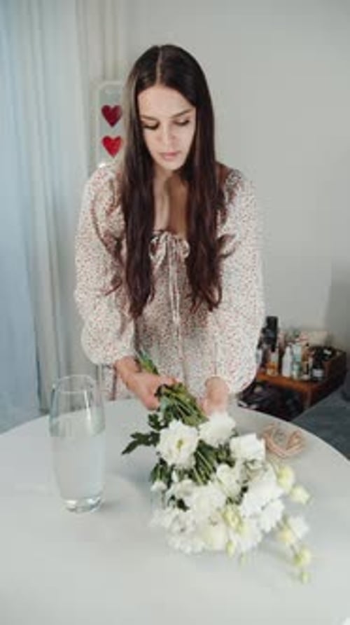 Woman Arranging Fresh Flower Bouquet at Home