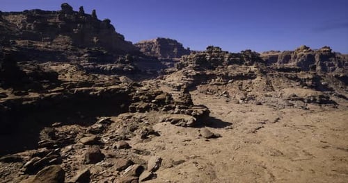 Stark Desert Landscape Showcasing Unique Rock Formations and Clear Blue Sky
