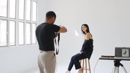 Photographer Taking Pictures of Model Posing in Photo Studio
