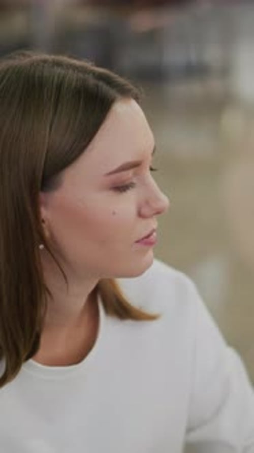 Young Woman Drinking with Straw in Urban Setting