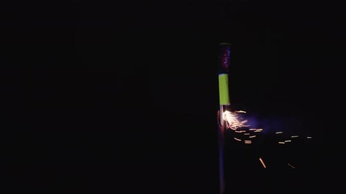 Starting fireworks rocket with lighter in hand, safe pyrotechnics